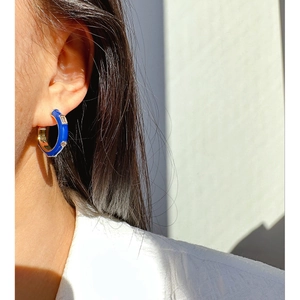 Chic blue enamel C-shape hoop earrings with white zircon crystals on female model