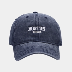 Detailed view of vintage washed blue cotton baseball cap with white Boston 1630 embroidery