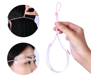 Detailed view of the eyebrow mapping ruler with pink string for precise face positioning