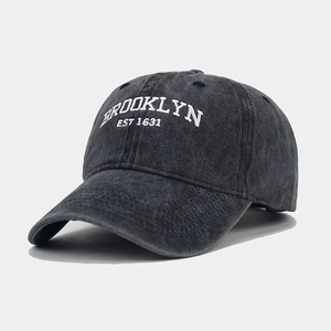 Close-up of vintage washed canvas baseball cap with Brooklyn embroidery and worn texture
