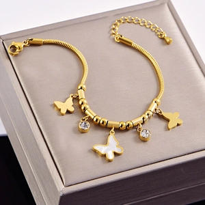 Golden butterfly snake chain bracelet with white shell pendant and sparkling zircons