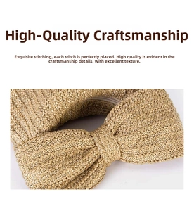 Detail of woven straw handbag featuring a large bow design and metal zipper closure