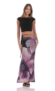 Detail of summer mesh long skirt featuring purple floral print and waist tie design