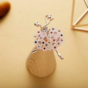 Macro detail of ballerina brooch featuring colorful rhinestones and floral skirt design