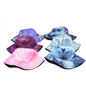 Flat lay of bucket hats featuring marble print patterns in multiple colors and wide brims