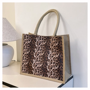 Detailed close-up of leopard print linen tote bag with textured woven handles