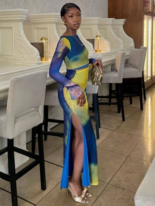 Detail of gradient print crop top and high waist side slit skirt set in lounge setting