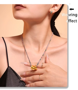 Model wearing a 316L gold-plated necklace with colorful zircons and stacked gold rings