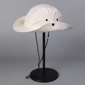 Detail of outdoor sun hat with black metal ventilation eyelets and adjustable wind rope