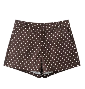 Detail of brown polka dot mini shorts with side pockets and smooth waistband design