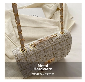 Detail of tweed crossbody bag featuring gold chain strap and metallic twist lock closure