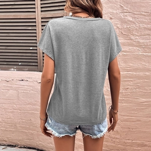 Women's casual loose grey U-neck short sleeve T-shirt paired with denim shorts