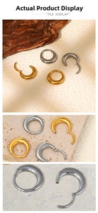 Detail showing gold and silver crescent 316L stainless steel clicker rings for septums
