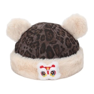 Detail of leopard print winter hat with plush pompoms and lion dance embroidery