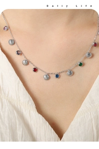 Detail of silver shell pendant necklace with colorful cubic zirconia on model