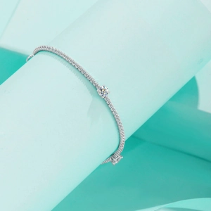 Elegant S925 sterling silver moissanite bracelet with round center diamond on blue background