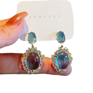 Elegant mint blue cat eye stone earrings with zircon set in gold plating