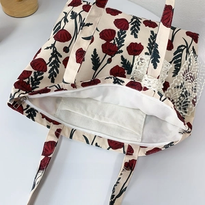 Detail view of canvas tote bag showing secure zipper closure and inner organizer pocket