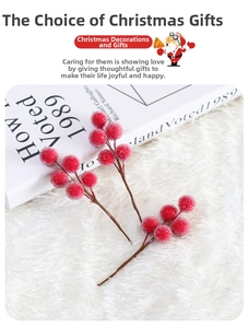 Close-up of frosted red Christmas berries on branches over a soft white plush background
