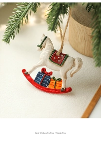 Close-up of vintage resin rocking horse Christmas ornament with colorful gifts details