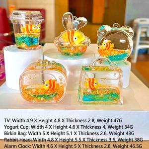Close-up of acrylic liquid keychains with clownfish models and floating sequins