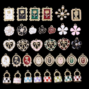 Assorted enamel alloy bag charms featuring roses and bows with pearl and crystal details