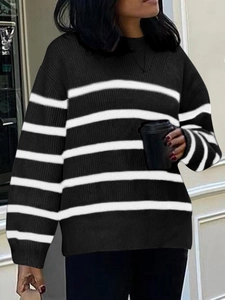 Detailed texture of black and white striped long sleeve knit sweater on female model