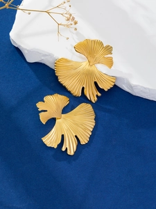 Detailed view of 18K gold plated stainless steel ginkgo leaf earrings with fine texture