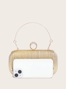 Golden fringe evening bag with crystals showing size scale next to a smartphone