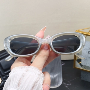 Vintage oval translucent grey sunglasses with thick temples and dark lenses in a Y2K style