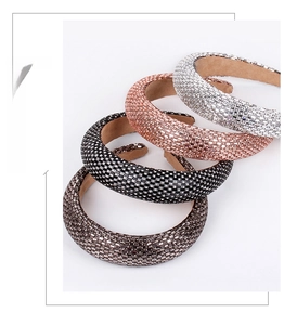 Detail of four padded rhinestone headbands in silver, rose gold, black, and bronze colors