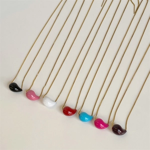 Detailed view of colorful drop-shaped pendants on gold chains in seven vibrant shades