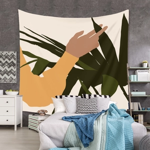 Modern abstract tapestry with orange sleeves and green leaves over a bedroom headboard