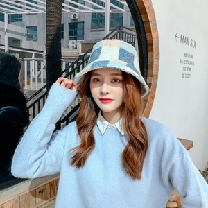 Close-up of blue and white checkered teddy plush bucket hat with thick wool texture