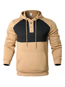 Detail view of khaki and black patchwork hoodie with three-button neckline and soft fabric