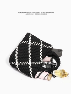 Detail shot showing the spacious capacity of this black and white woven tote bag