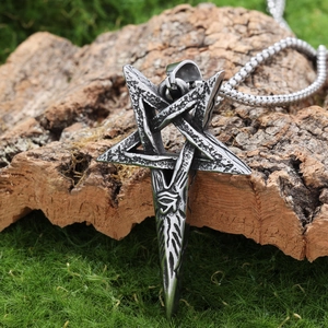 Detail of vintage silver pentagram pendant with eye of Horus on a natural moss background