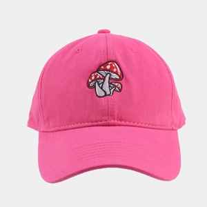 Close-up of three red mushroom embroideries on pink cotton canvas baseball cap
