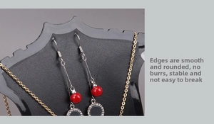 Detail of plastic jewelry organizer showing red bead earrings and golden necklace display
