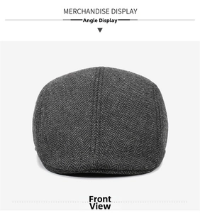 Detail of grey herringbone pattern wool fabric on a classic flat cap for winter