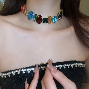 Close-up of luxury choker necklace featuring multi-colored geometric crystal gemstones