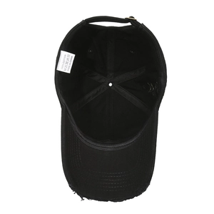 Internal view of distressed black cotton baseball cap showing frayed brim and 6-panel structure
