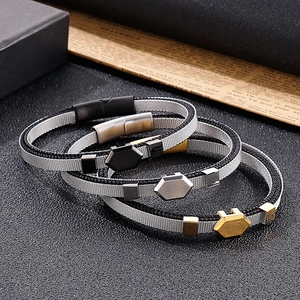 Three men's woven mesh bracelets with hexagonal metal charms in black silver and gold