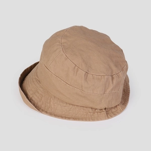Close-up of khaki cotton bucket hat showing reinforced stitched brim for outdoor wear