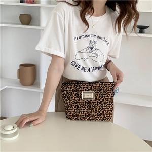 Close-up of leopard print canvas makeup bag with zipper and Pleasant Time label