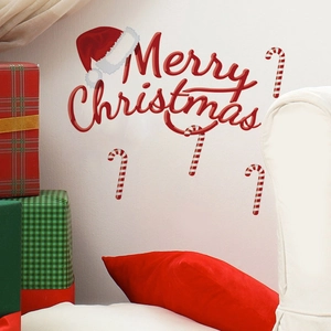 Merry Christmas wall decal with red lettering, Santa hat, and candy canes on a white wall