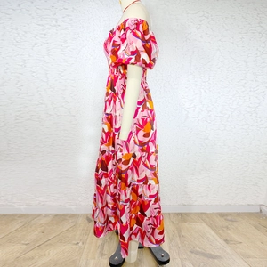 Side view of puff sleeve floral maxi dress with vibrant geometric patterns on mannequin