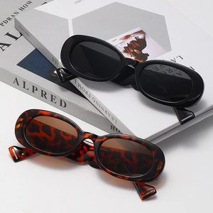 Vintage oval sunglasses for women in glossy black and tortoise shell frames