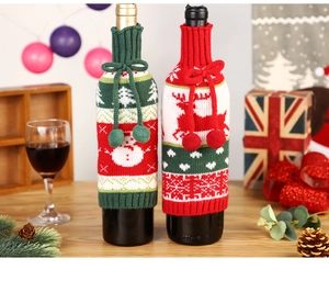 Festive knitted wine bottle covers with snowman and reindeer designs on a holiday table