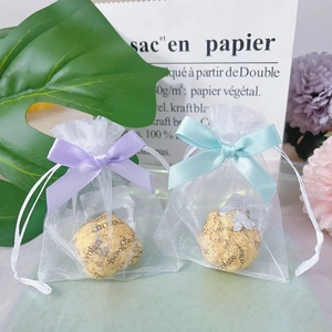 Mini white organza gift bags with colorful silk bows and drawstring closure for weddings
